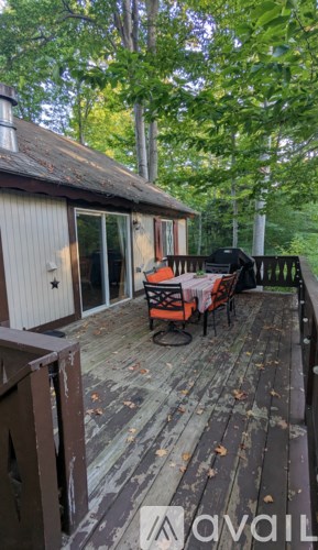 A wooden deck with a table and chairs.