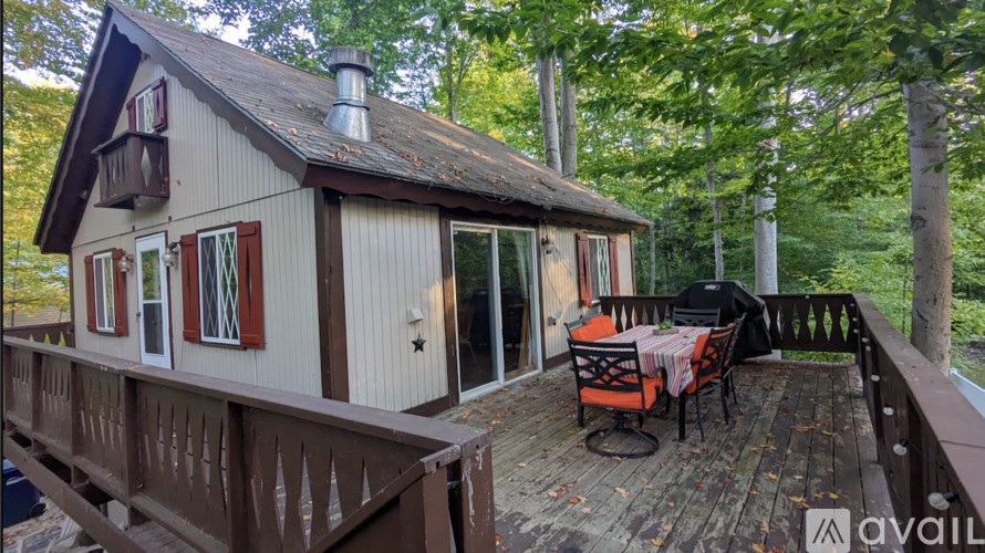 A small cabin with a porch and a table set for two.
