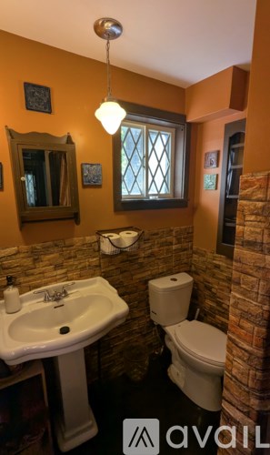 A bathroom with a white sink and toilet.
