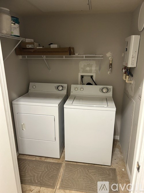 A long hallway with doors on the left and a light at the end.