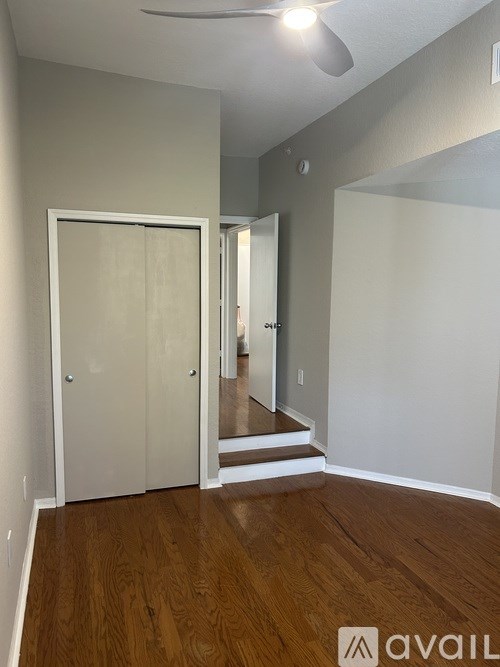 A room with a wooden floor and a white door.