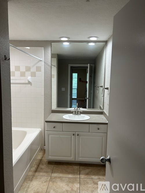 A bathroom with a white sink and a white bathtub.