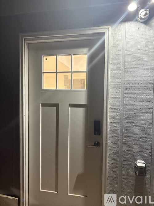 A glass door with a handle and a lock.