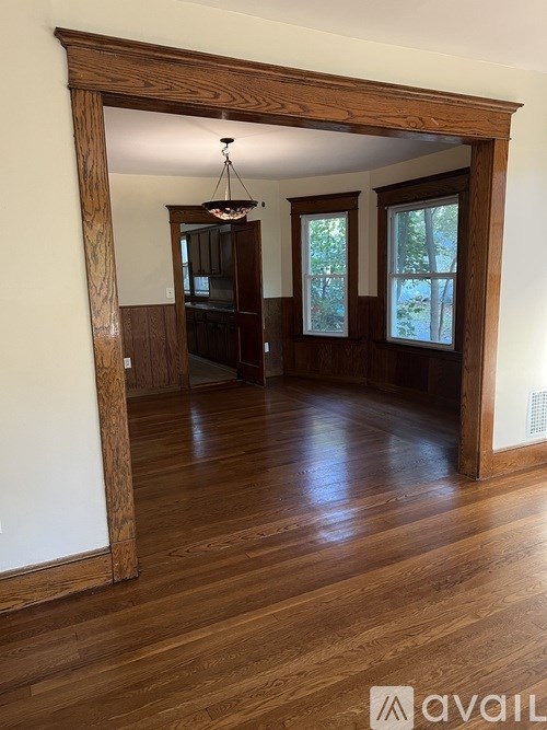 A room with wooden floors and a large wooden doorway.