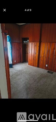 A room with wooden walls and a carpeted floor.