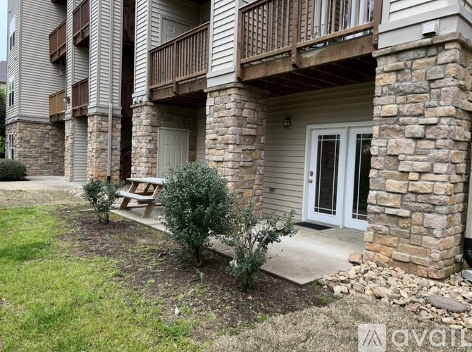 A building with a balcony and a door is shown.