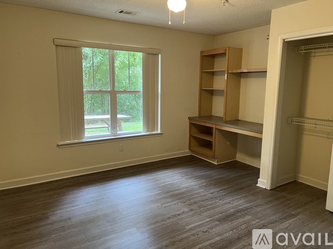 A room with a window and a shelf is available for rent.