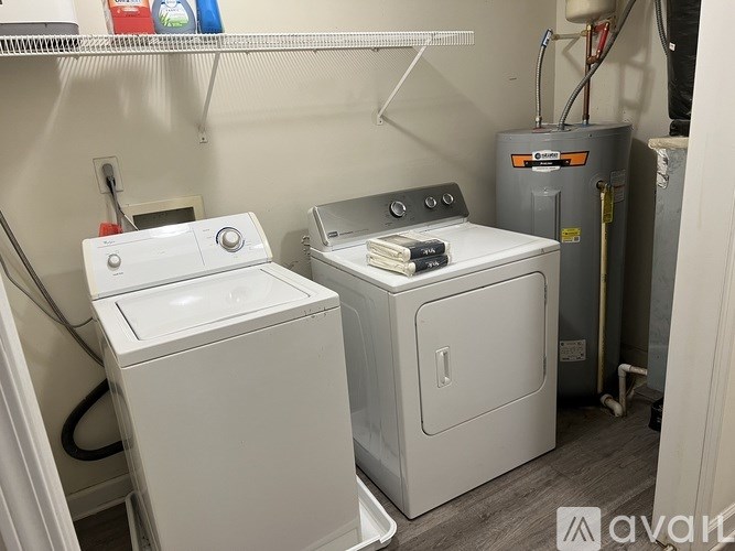 A small laundry room with a washer and dryer.