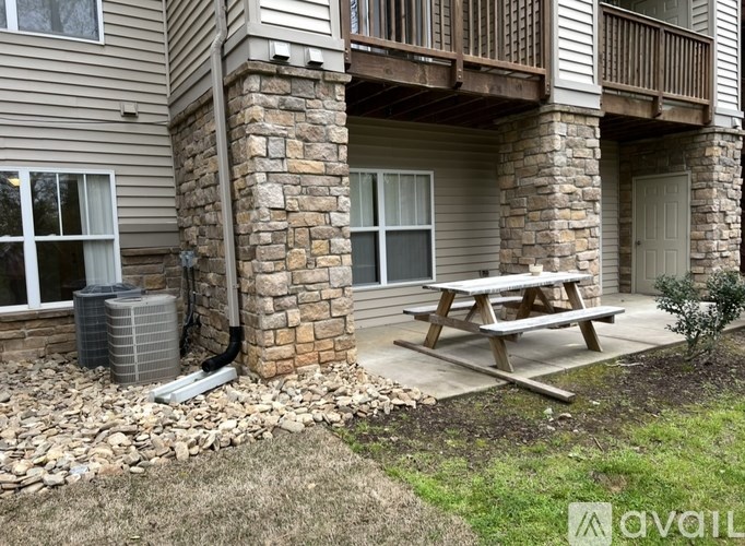 A stone pillar supports a wooden deck.