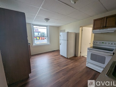 A kitchen with a white fridge and stove top oven.