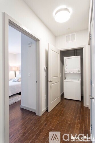 A small white laundry room with a washer and dryer.