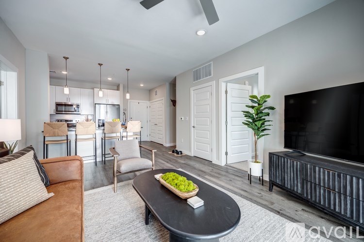 A living room with a black table and a television on the wall.