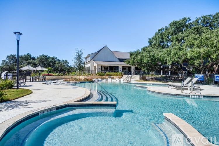 A large outdoor swimming pool with a building in the background.