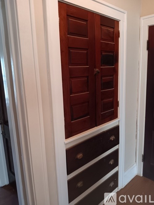 A brown door with a white frame is in the middle of a room.