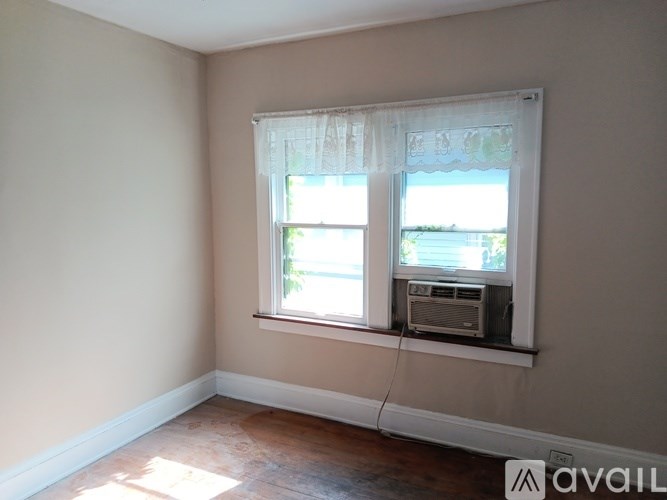 A room with a window and air conditioner.