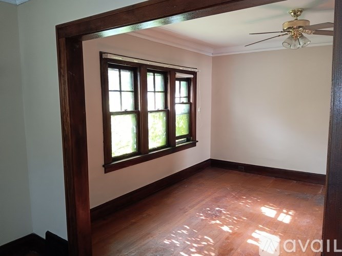 A room with a window and wooden floors is available.