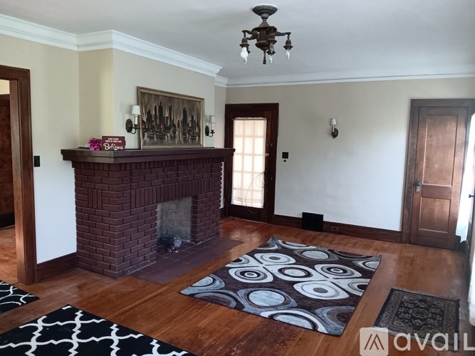 A living room with a fireplace and a chandelier.