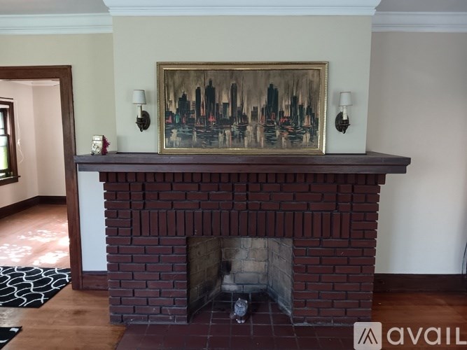 A fireplace with a painting above it in a room.