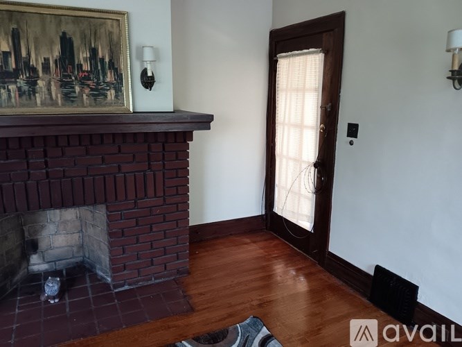 A room with a fireplace and a painting on the wall.