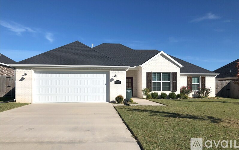 A house with a white garage door and a black roof.