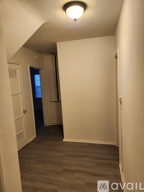 A hallway with a door on the left and a door on the right.