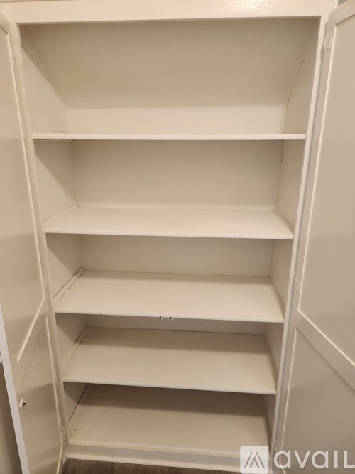 A bathroom with a tiled shower and a window.