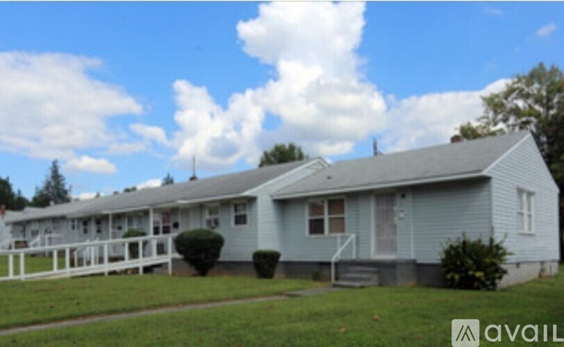 A house with a white fence in front of it.