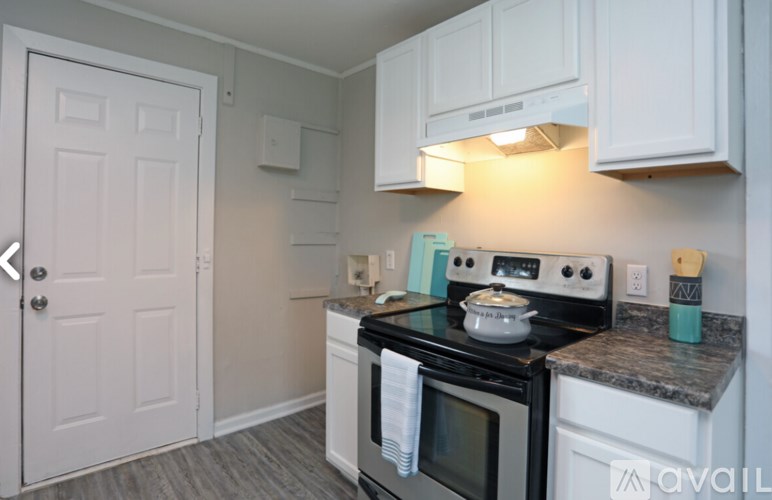A kitchen with a white oven and microwave.