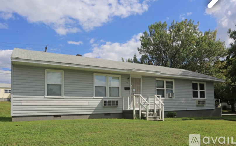 A grey house with a white door and windows.