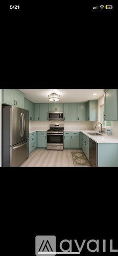A kitchen with a refrigerator, stove, and sink.