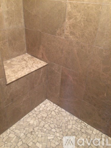 A tiled shower with a bench seat.