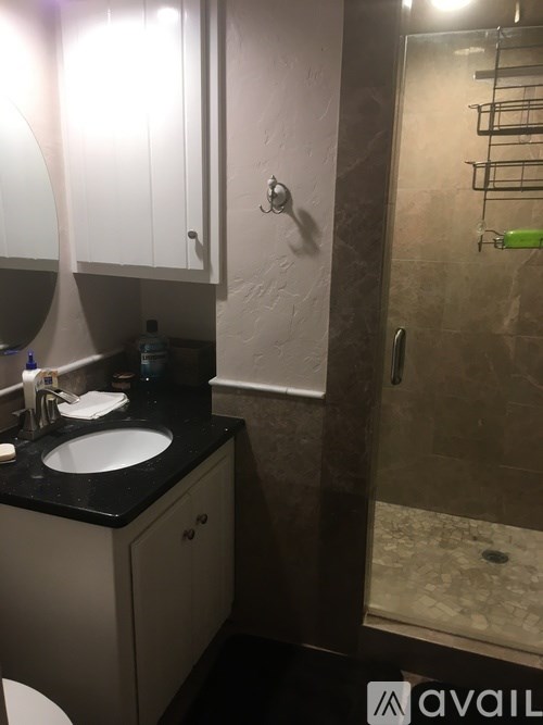 A bathroom with a sink, mirror, and toilet.