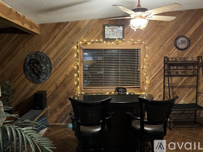 A room with wooden walls and a ceiling fan.