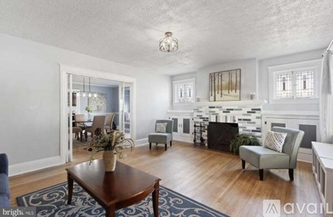 A living room with a brown coffee table and a grey armchair.