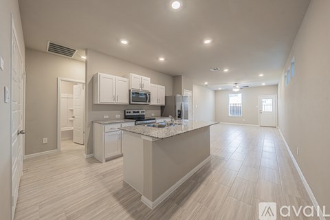 A kitchen with a countertop and cabinets is shown in this image.