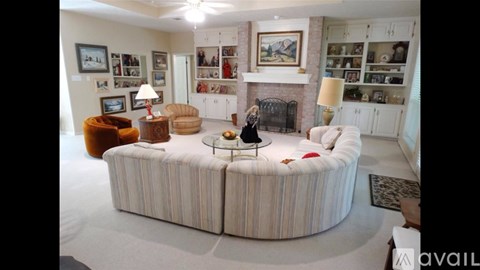 A living room with a large sofa and a fireplace.