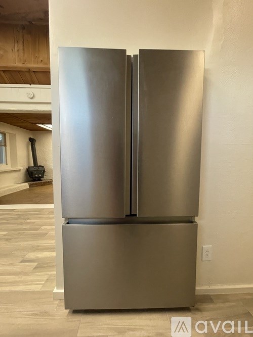 A stainless steel refrigerator in a kitchen.