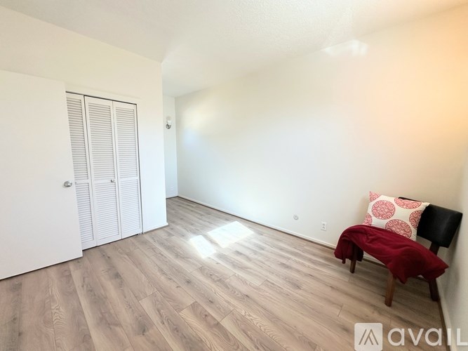 A room with a bench and a door.