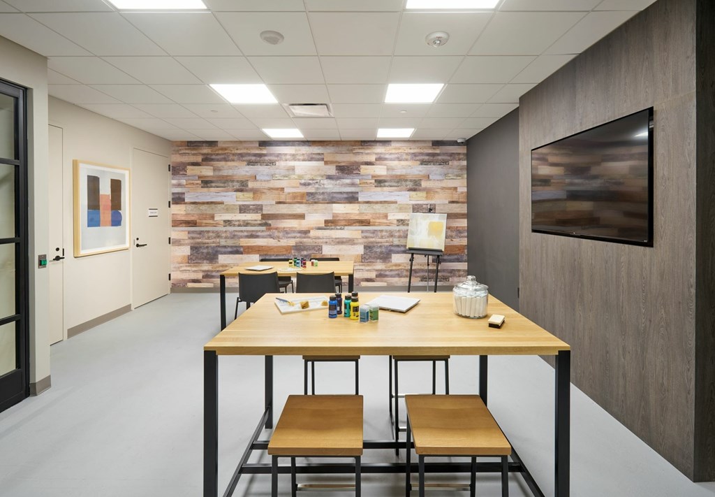 A conference room with a wooden table and chairs.