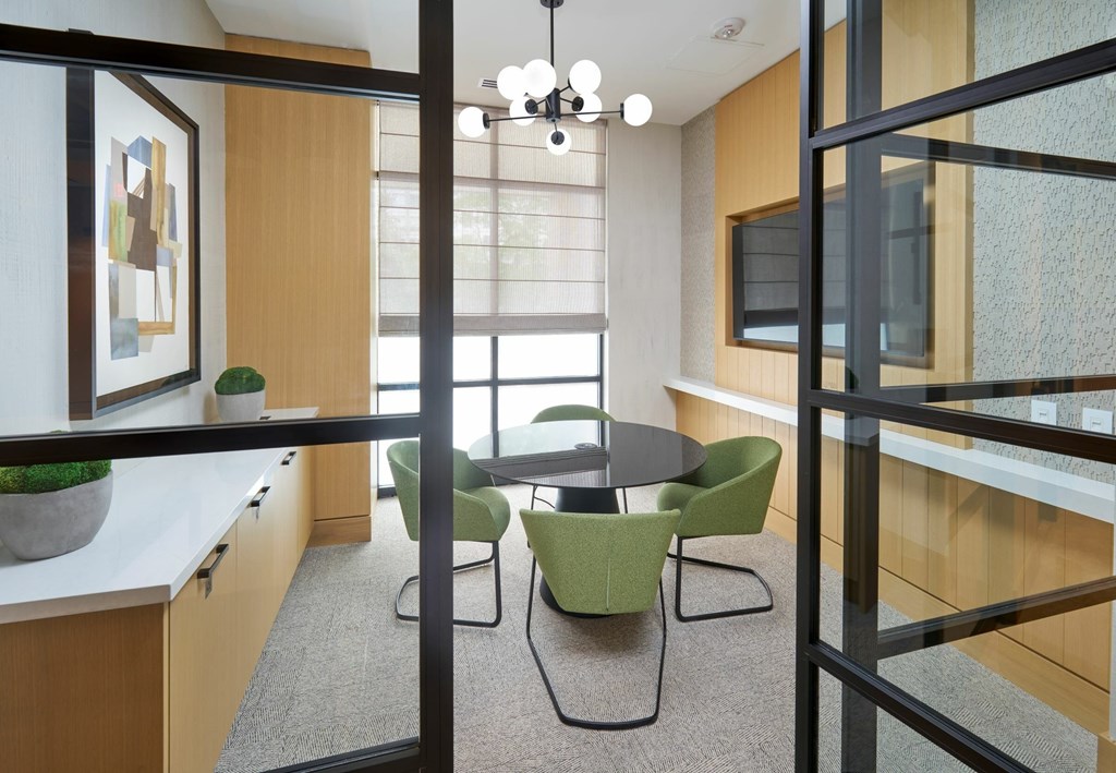 A conference room with a table and chairs.