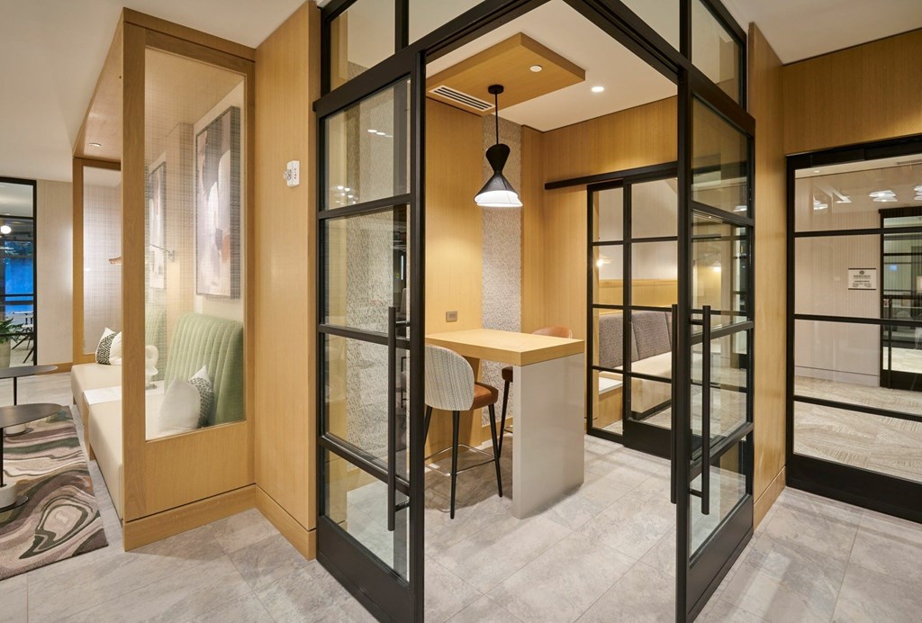 A modern room with a table and chairs in the center.