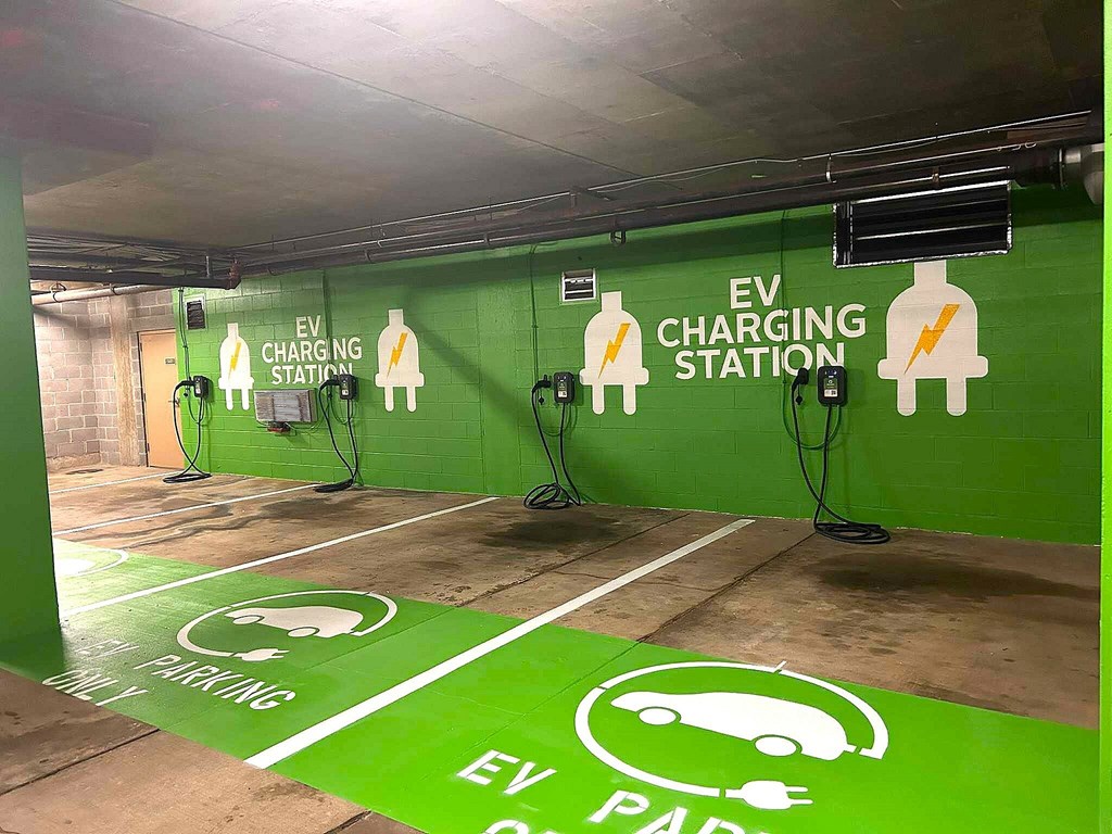An EV charging station is in a parking garage.