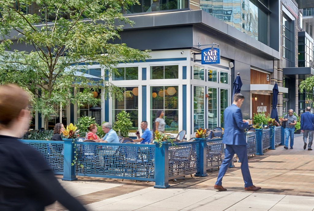 A man in a blue suit walks past a Salt Line restaurant.
