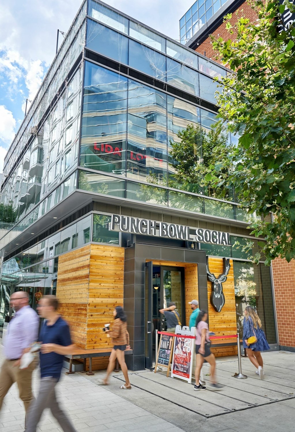 A modern building with a glass facade and a wooden exterior.