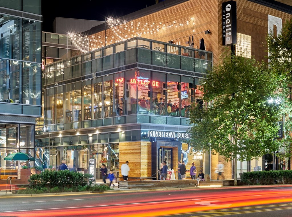 A building with a sign that says "Punchbowl" is lit up at night.
