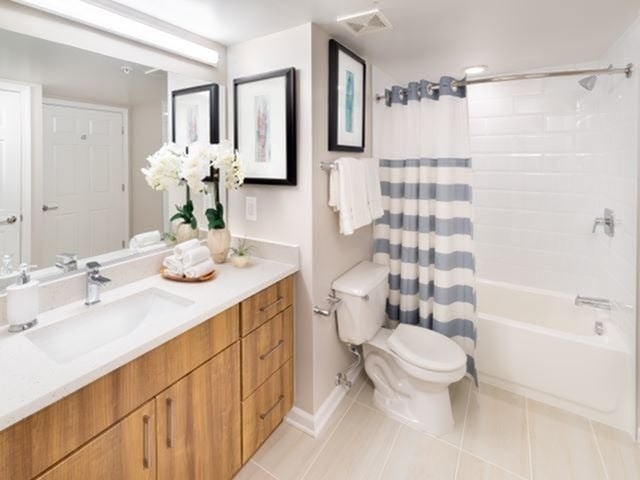 A bathroom with a toilet, sink, and shower.