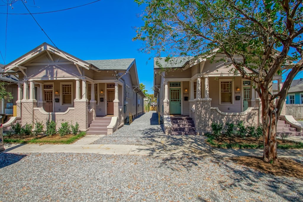 A row of houses with gravel driveways in front.