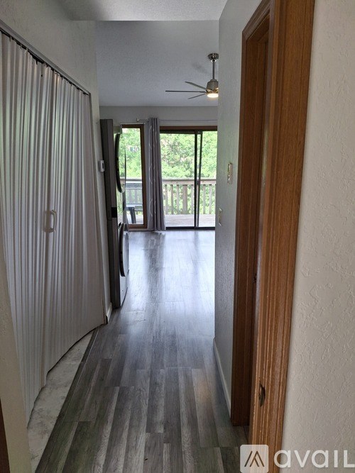 A long hallway with a sliding glass door at the end.