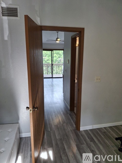 A room with a wooden door leading to a balcony.