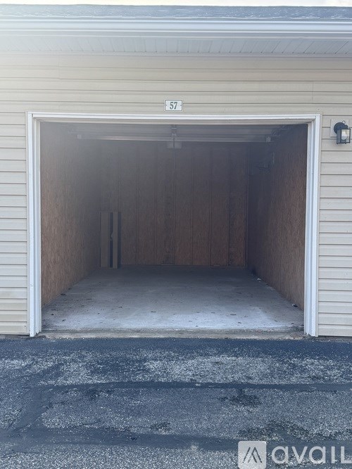 A white garage door with the number 572 on it.